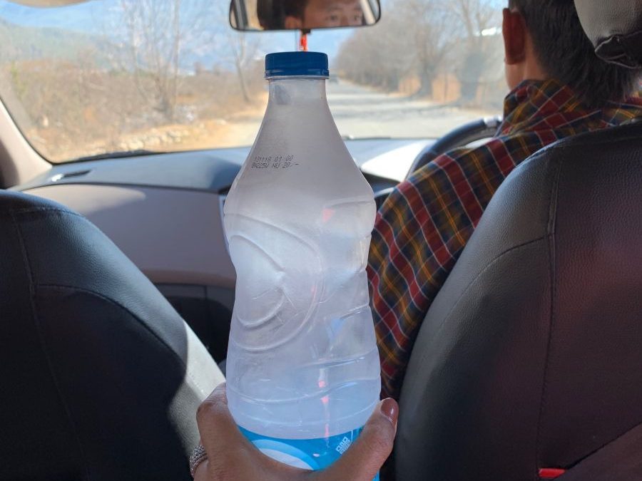 a frozen water bottle in the car