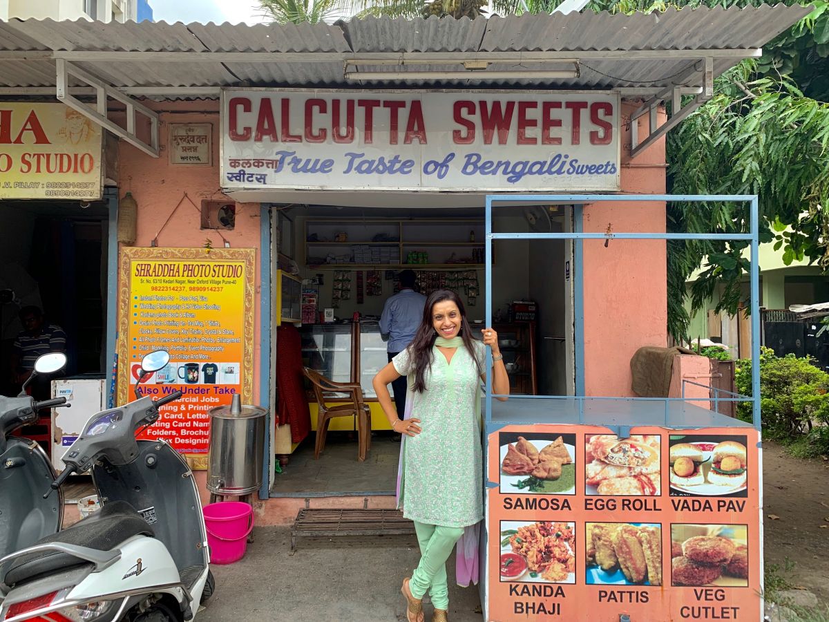 The Bengali in front of the Bengali sweet shop.