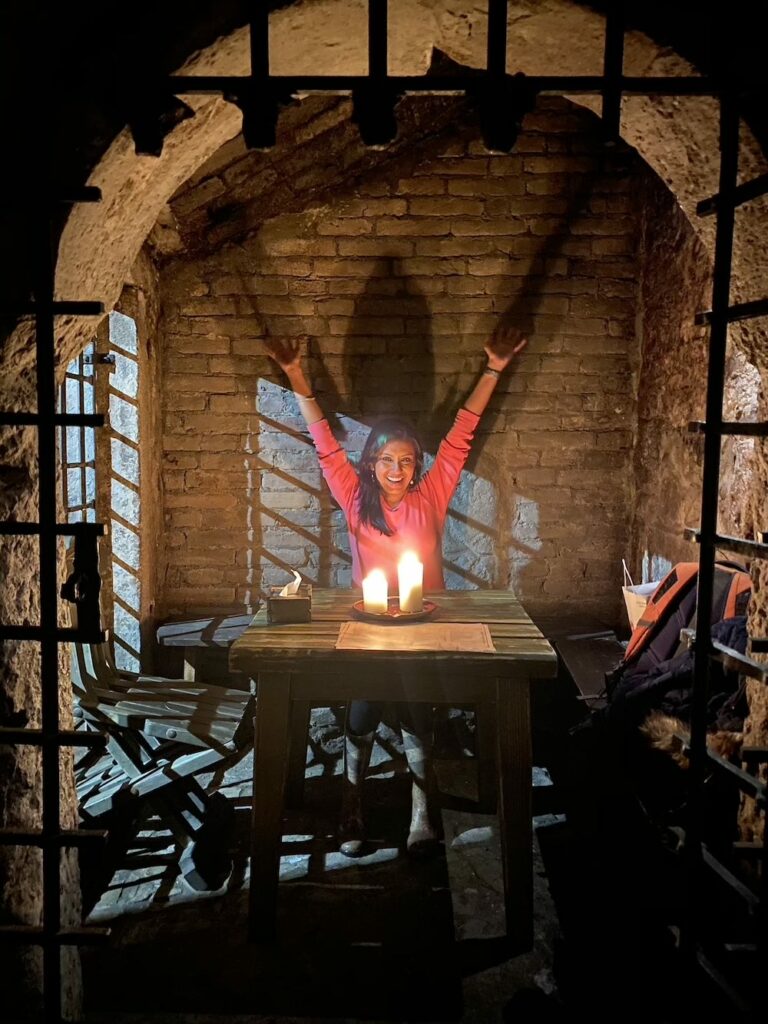 Dining inside a cell in a dungeon.